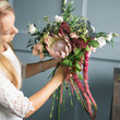 © cherry_d - Florist at work: pretty young blond woman making fashion modern bouquet of different flowers