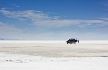 car in Salar de Uyuni on white surface