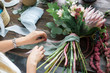 © cherry_d - Florist at work: pretty young blond woman making fashion modern bouquet of different flowers