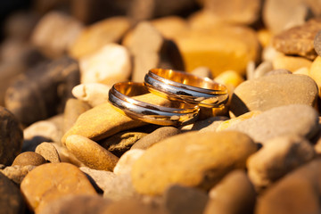 Wedding gold rings on the rocks