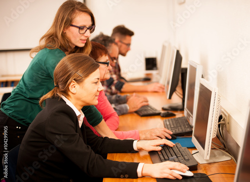 Fotografie, Obraz Group of adults learning computer skills. Intergenerational tran