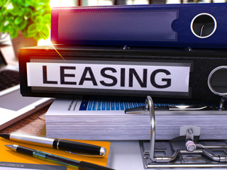 Poster - Black Office Folder with Inscription Leasing on Office Desktop with Office Supplies and Modern Laptop. Leasing Business Concept on Blurred Background. Leasing - Toned Image. 3D Render.