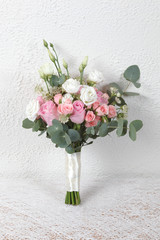 White and pink wedding bouquet of roses and lisianthus flowers