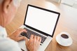 © WavebreakMediaMicro - Focused elderly man typing on laptop