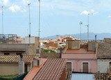 Fototapeta Paryż - Tiled roofs of old buildings in Figueres, Catalonia, Spain.