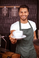 Smiling barista holding espresso