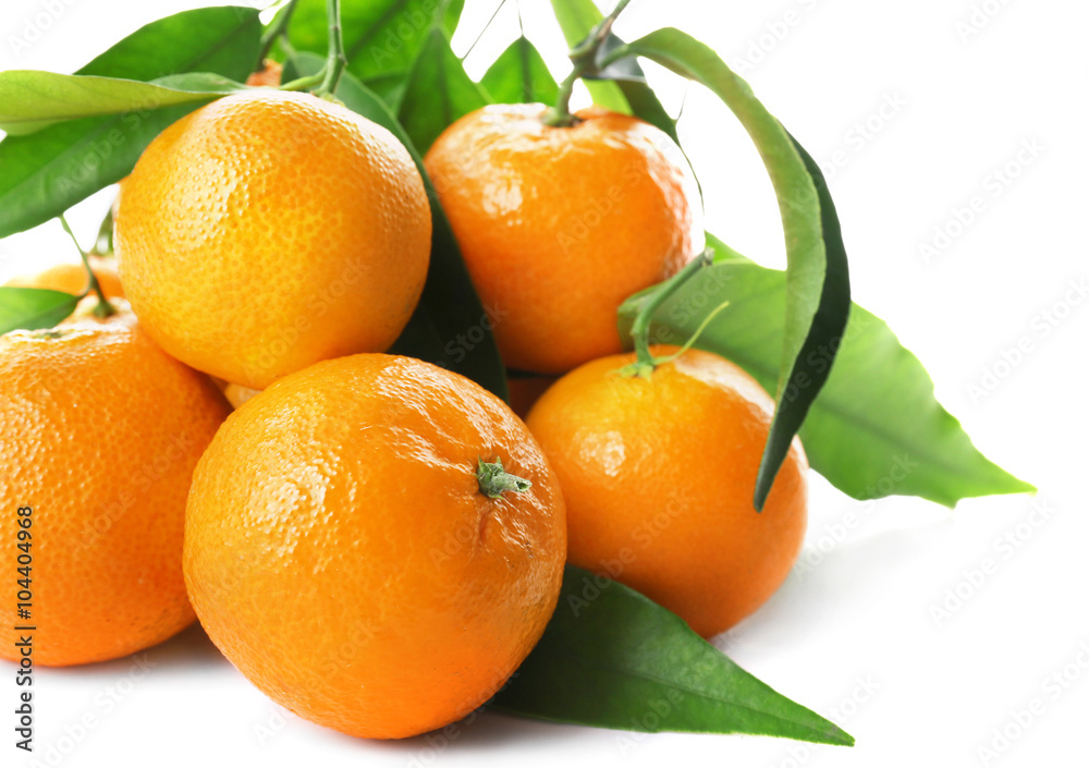 Ripe tangerines with green leaves isolated on white