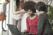 © Westend61 - Young women looking at laptop