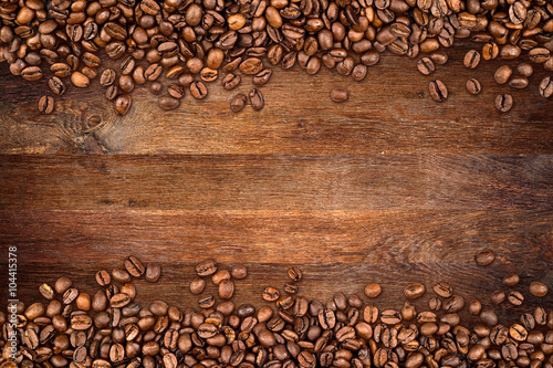 Naklejka dekoracyjna coffee background with beans on rustic old oak wood