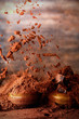 Falling cocoa powder on wooden table