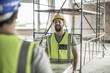 © Westend61 - Two construction workers carrying item in construction site