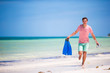 © travnikovstudio - Young man with mask and fins. Holiday vacation on a tropical beach.