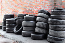 Used Tires At The Brick Wall Background