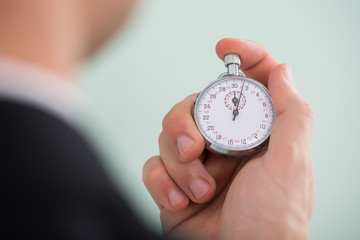 Person Hand Holding Stopwatch