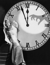 Woman With Huge Clock Recoiling From Frightening Hand 