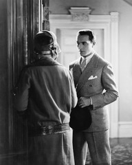 Man standing in front of a woman at the doorway 