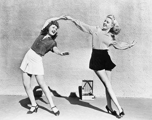 two women dancing outside