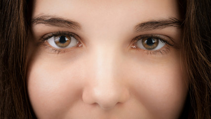 closeup portrait of young woman with hazel eyes, focus on eyes