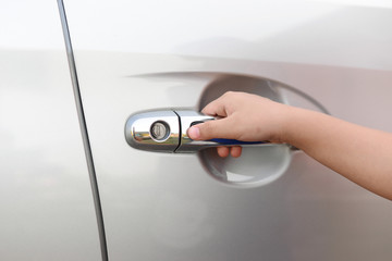 Hand boy pushing button of car handle to open car