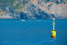 Inshore Yellow Buoy Floating In The Deep Blue Sea