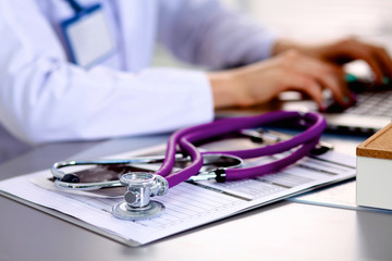 Wall Mural - Young doctor at the table is receiving patient