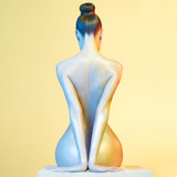 Elegant nude model in the light colored spotlights