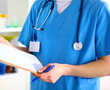 Closeup portrait of a doctor with stethoscope holding folder