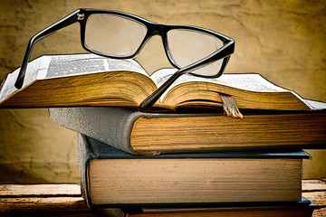 illustration of open book with reading glasses