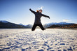 © goodmanphoto - young woman jumping for joy in the mountains