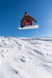 Fototapeta Panele - Snowboarder jumping against blue sky