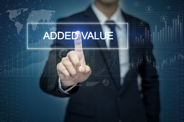 Wall Mural - Businessman hand touching ADDED VALUE  button on virtual screen