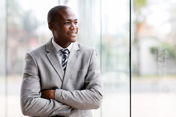 Wall Mural - black businessman looking outside window