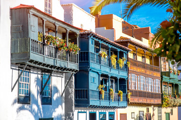 Wall Mural - Famous ancient colorful balconies decorated with flowers in Santa Cruz city on La Palma island in Spain