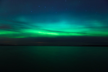 Wall Mural - northern lights over lake in finland