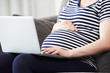 © highwaystarz - Close Up Of Pregnant Woman Using Laptop At Home