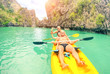 Group of elderly friends having fun taking selfie on kayak at Big Lagoon in El Nido Palawan - Cheerful tourists at Philippines popular travel attraction - Happy and sporty senior concept with sun halo