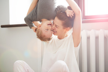 Happy family. Mother and son playing and smiling. Little boy having fun with his mother at home