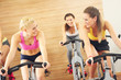 © Kalim - Sporty women on spinning class