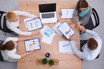 Wall Mural - Business people sitting and discussing at business meeting, in office