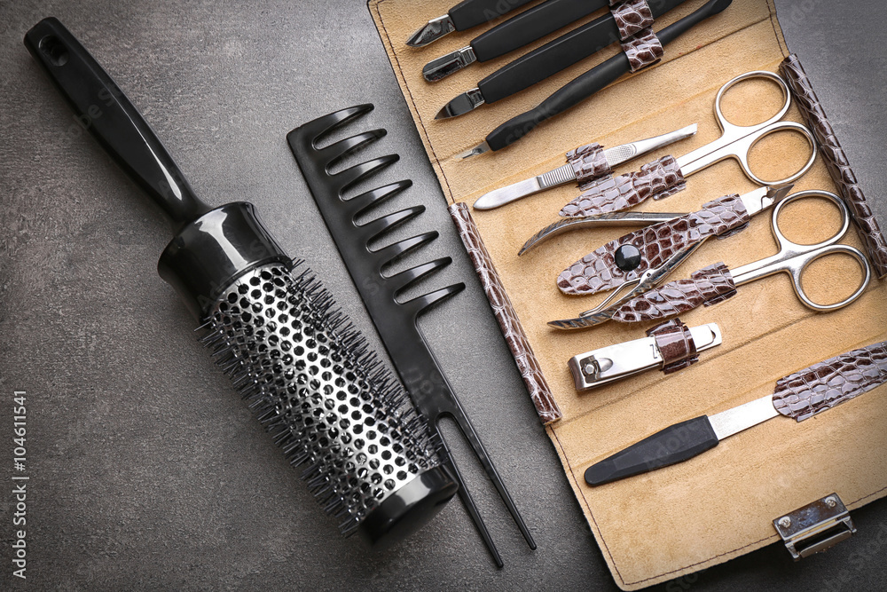 Manicure set with two combs on grey background, close up