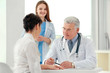 © Africa Studio - Doctors and patient in office