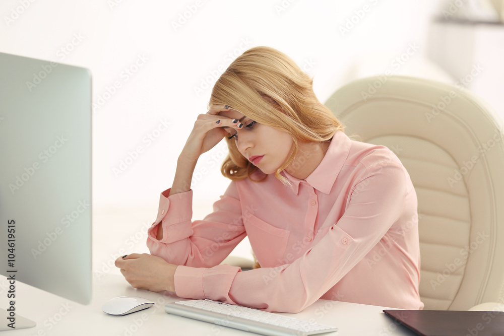 Tired woman at the computer in office