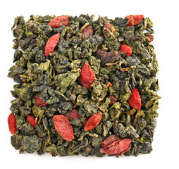 Pile of dry tea with goji berries, isolated on white