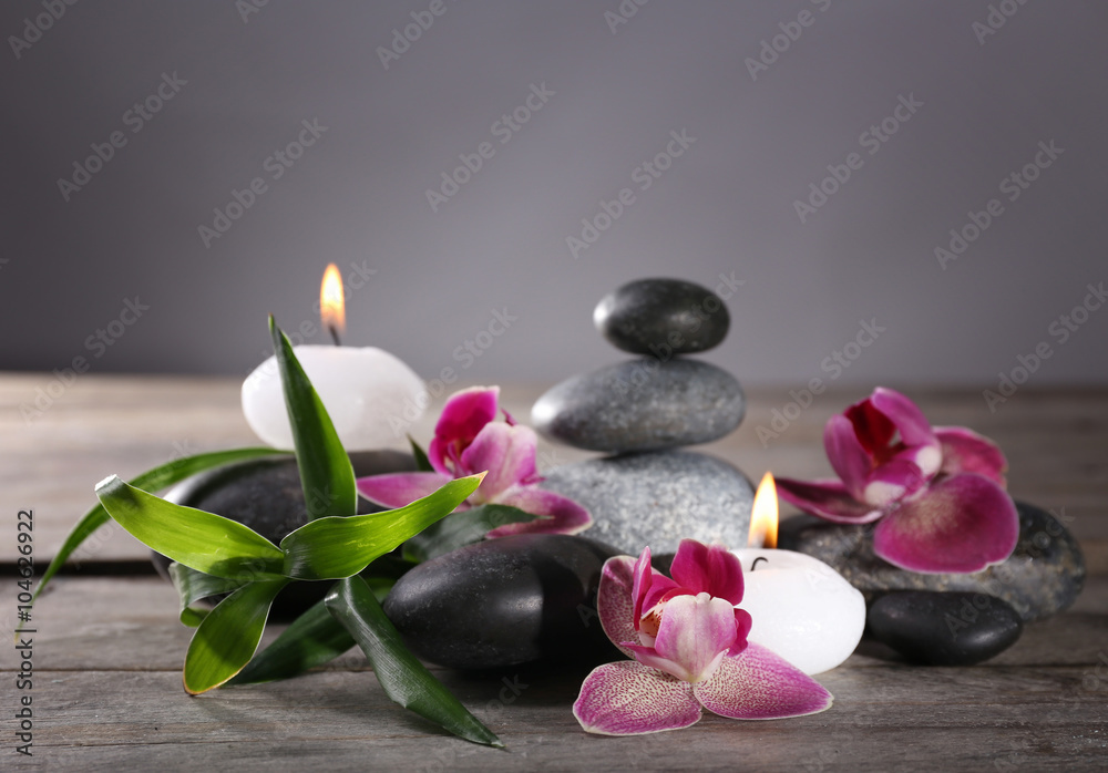 Spa still life with beautiful flower and candlelight on grey background