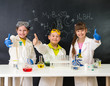 © tan4ikk - three little students on chemistry lesson in lab
