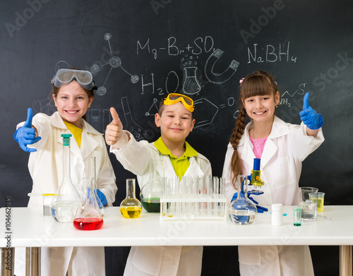 Fotografie, Obraz three little students on chemistry lesson in lab