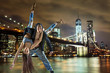 © konradbak - Young hip hop couple dancing, over urban background