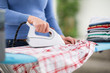 Woman from ironing services iron clothes.