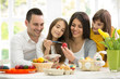 © luckybusiness - family together on Easter preparing eggs