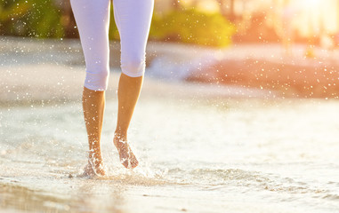 Canvas Print - Detail of woman legs running on beach